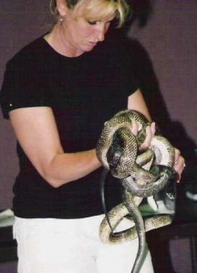 Woman holding snakes